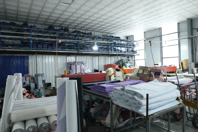 Fabric rolls spread on the automatic spreading line in the cutting room